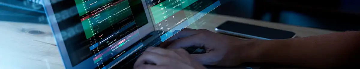 Hands on a laptop with development code