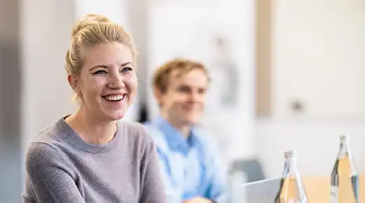 Smiling Woman and Man in the Office