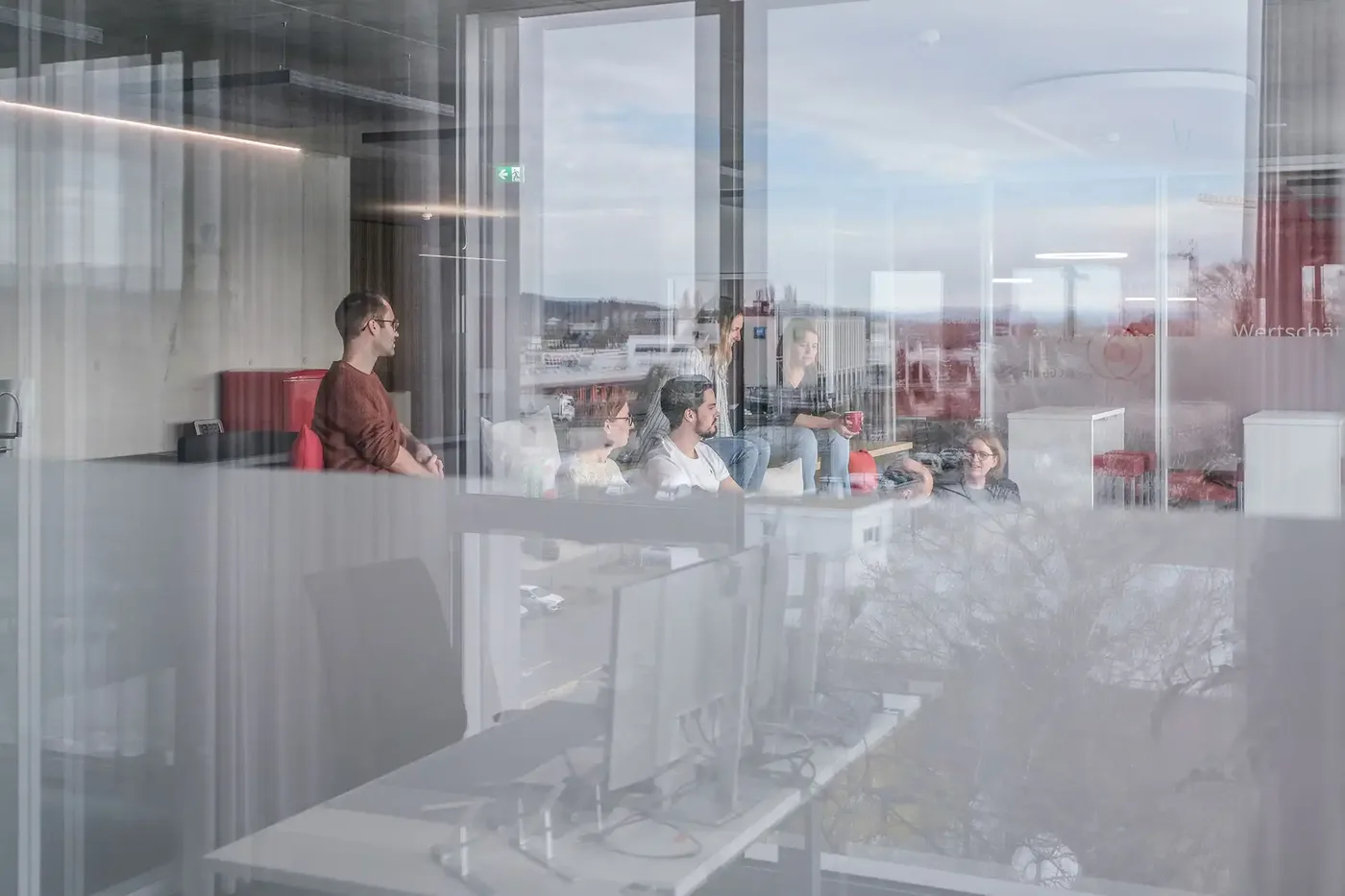 Johner Institute staff in discussion in a meeting room.