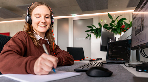 Woman with Headset Taking Notes
