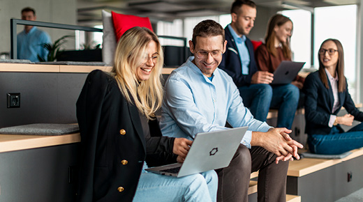 People in the Office Watching Something on the Laptop