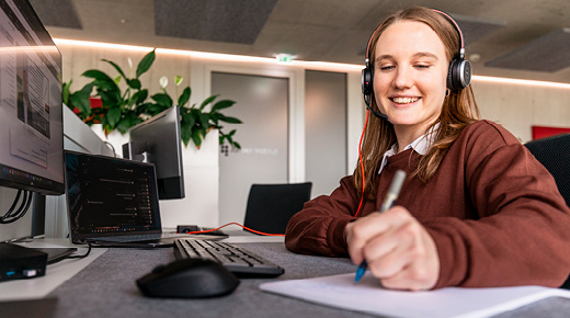 Woman With Headphones Taking Notes